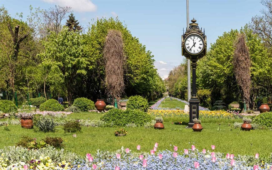 flowers and vintage watch at the entrance of cismigiu park